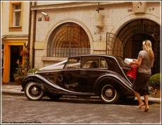 a car, a woman and a sunny noon