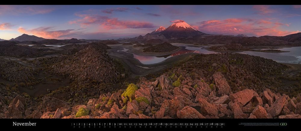 Parinacota (6332m) & Pomerape (6282m) Volcanoes and CotaCotani Lagoons (water mirror at 4517m) Lauca Biosphere Reserve, Chile. December 2011. Panoramic