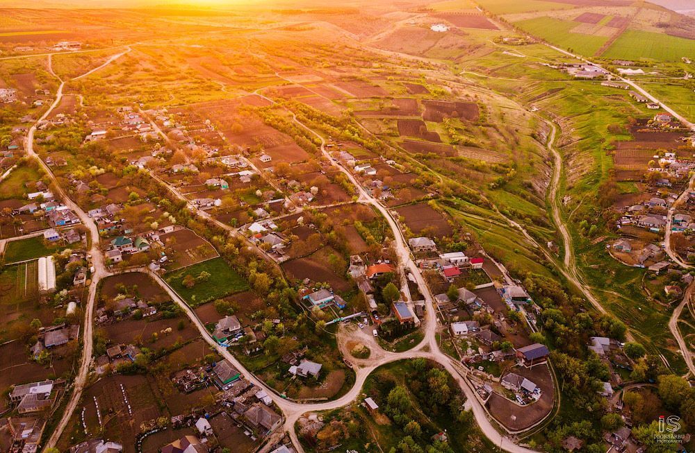 Flight over a little village at springtime