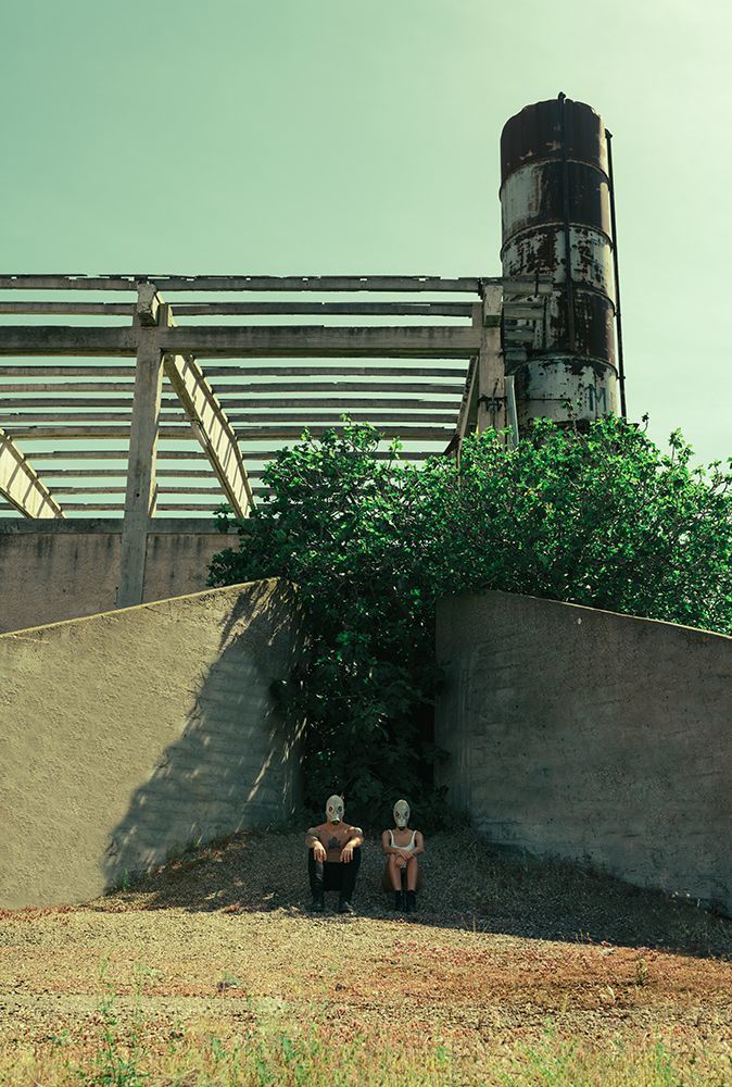 The World Beyond is a photographic project set in an apocalyptic scenario, a dystopian future in which our planet, now tired, old and victim of epidemics, natural disasters, pollution has now ceased to be what we knew. The air is now unbreathable and it is quite difficult to survive. This photographic story is set in this scenario, which sees two people as protagonists, a couple of young guy and girl, who try to survive in this hostile world full of pitfalls but poor in resources. The images want to represent a sort of story by expressing different emotional states that young people experience during their daily life. In this case exploring a new, abandoned and declining place to rest and refresh for some time in search of better accommodation along their path. The cut is purely cinematic especially for the particularity of the shots, plays of light and shadows, symmetries and depth.