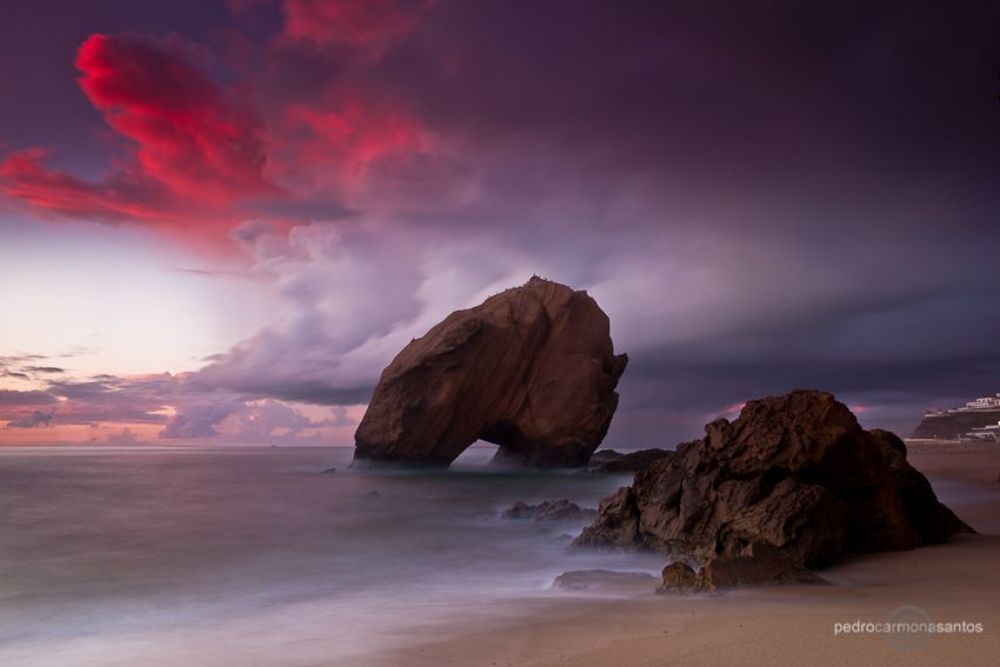 "The red cloud", photographed at Santa Cruz beach, with it's big rock called "penedo do guincho"; Visit me at (Посетите меня на)
http://www.pedrocarmonasantos.com/