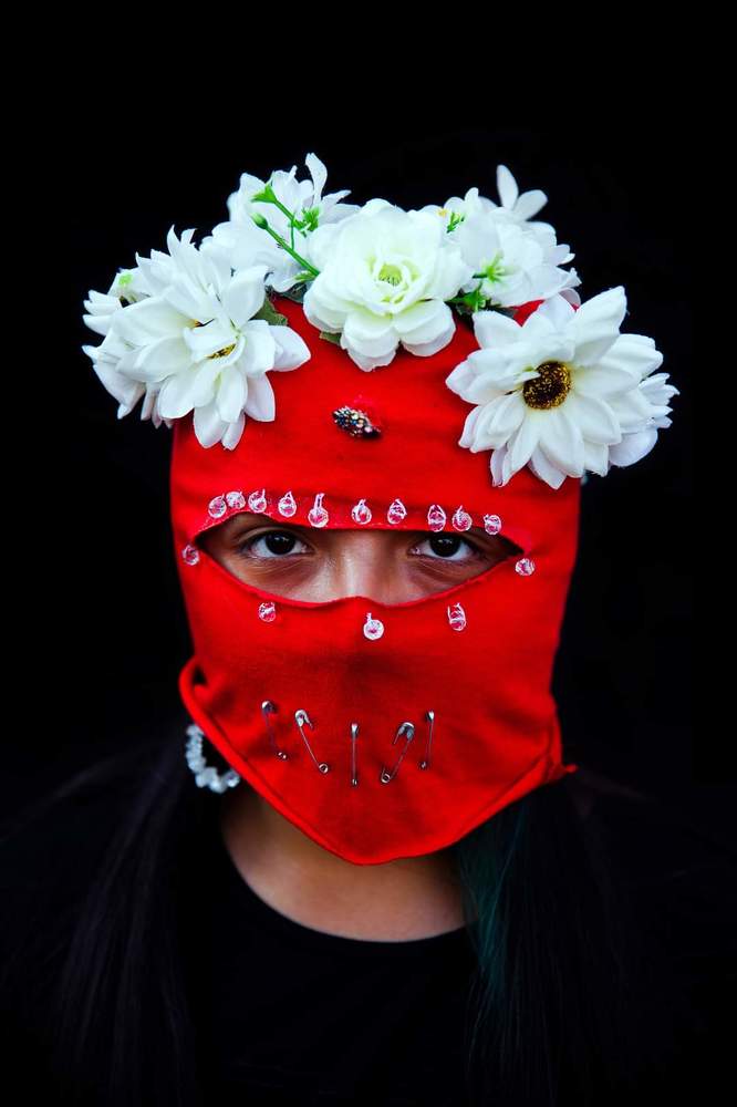 Baila Capucha Collective&rdquo;   Women from the &ldquo;Baila Capucha&rdquo; Collective pose with their red hoods to protect their identity due to fear of being imprisoned, discriminated or fired from work for participating in the protests held in the context of the social revolt against the neoliberal economic system and the government of Sebasti&aacute;n Pi&ntilde;era in Chile.  The Baila Capucha is a group of dissidents, self-organized women that dance with their faces covered by bright red and black hoods in order to remain anonymous and protect members while they express themselves by way of dance.  The feminist collectives in the protests of the social revolt played different roles. In addition to being at the heart of the changes demanded by women in terms of justice and work conditions, they also play a leading role in society.