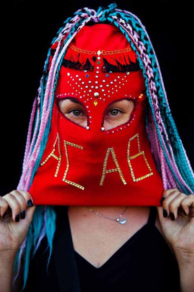 Baila Capucha Collective&rdquo;   Women from the &ldquo;Baila Capucha&rdquo; Collective pose with their red hoods to protect their identity due to fear of being imprisoned, discriminated or fired from work for participating in the protests held in the context of the social revolt against the neoliberal economic system and the government of Sebasti&aacute;n Pi&ntilde;era in Chile.  The Baila Capucha is a group of dissidents, self-organized women that dance with their faces covered by bright red and black hoods in order to remain anonymous and protect members while they express themselves by way of dance.  The feminist collectives in the protests of the social revolt played different roles. In addition to being at the heart of the changes demanded by women in terms of justice and work conditions, they also play a leading role in society.