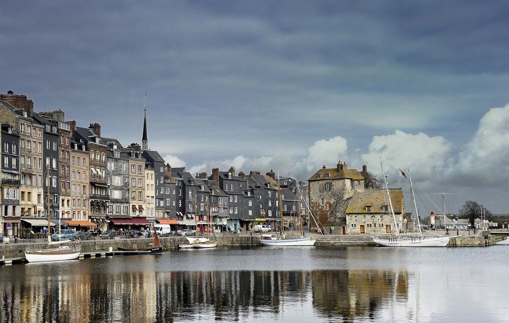 The harbour of Honfleur in Normandy near the famous "Pont de Normandy" where the Seine river flows into the sea. It only has about 8000 inhabitants but in the summer season thousands of tourists visit this place each year.