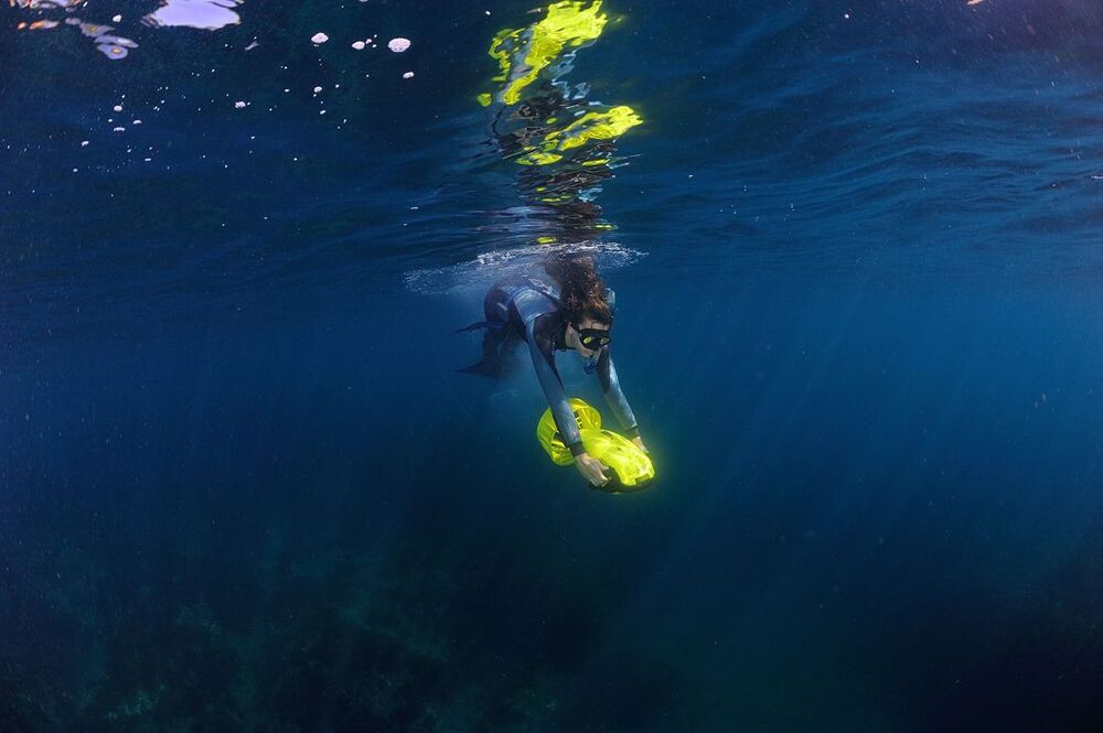 Japan Sea. Mermaid with scooter.