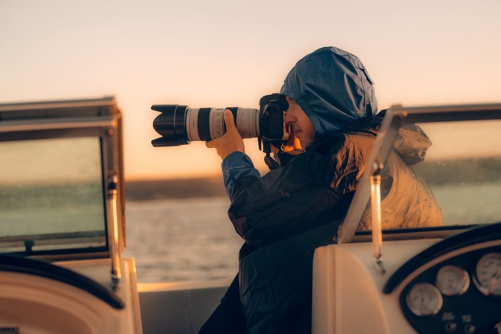 A photographer immersed in focus, painted by the warmth of golden hour