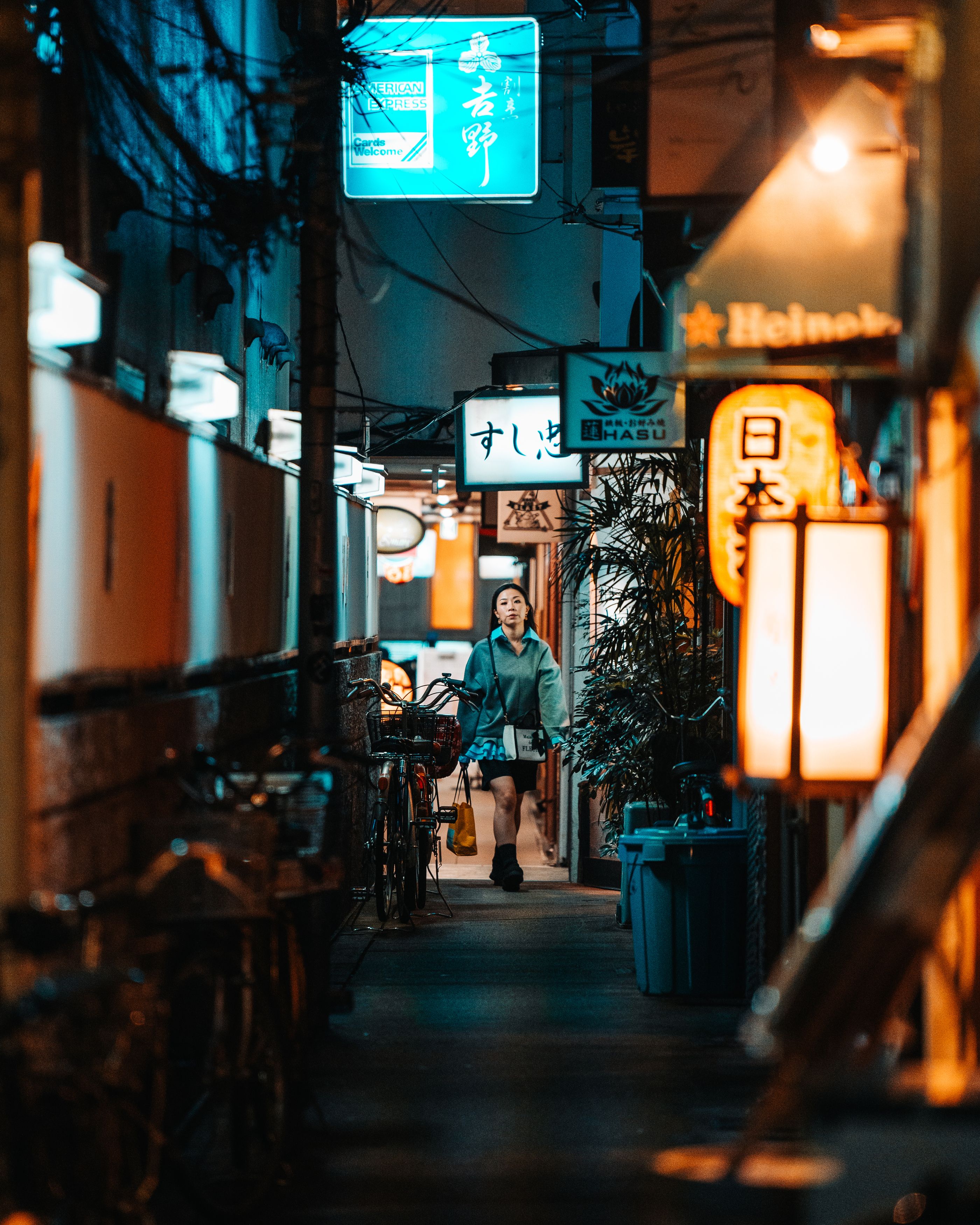 An atmospheric night shot in Dotonbori, where a traditional paper lantern and vibrant neon signs create a colorful composition.