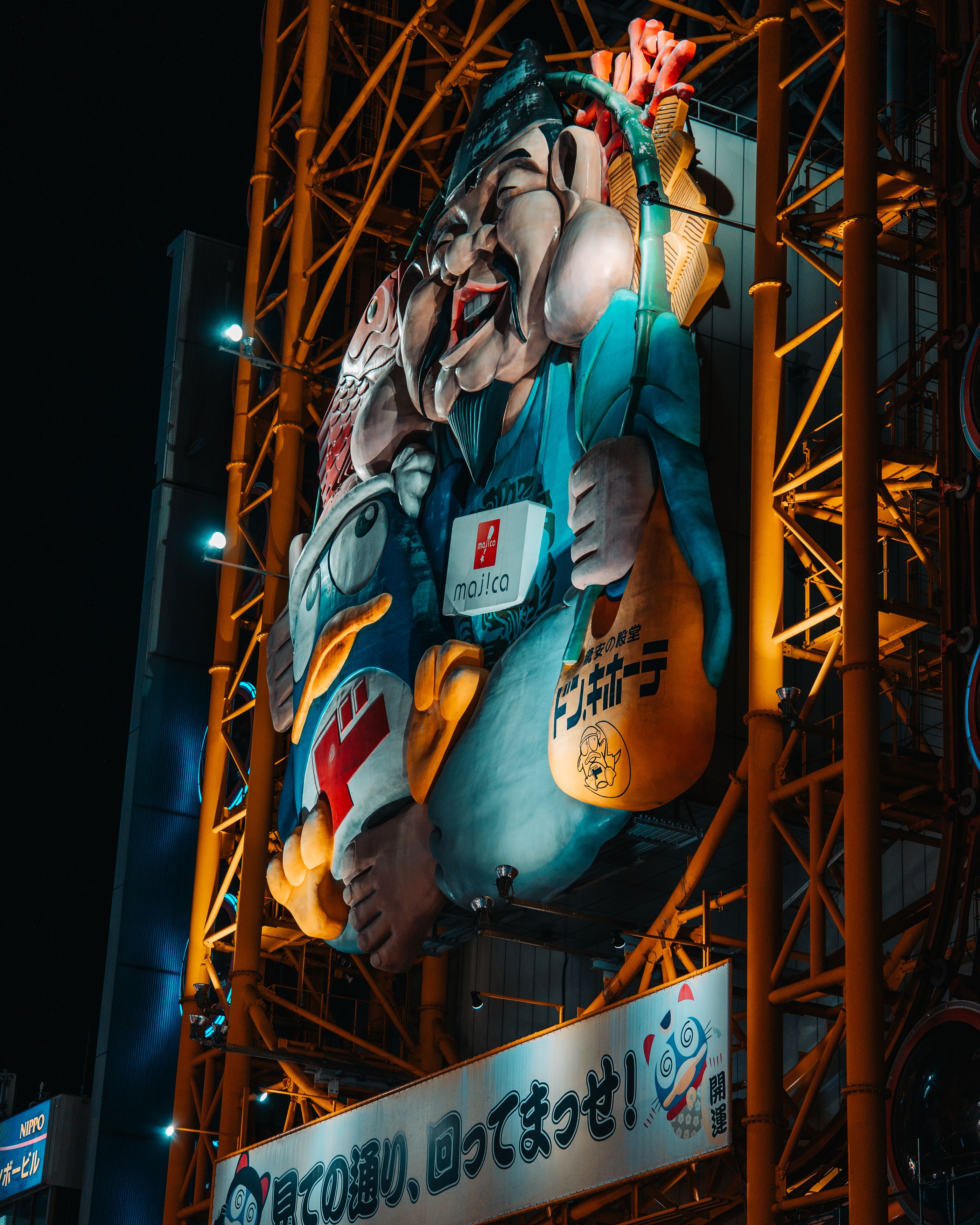 An atmospheric night shot in Dotonbori, where a traditional paper lantern and vibrant neon signs create a colorful composition.