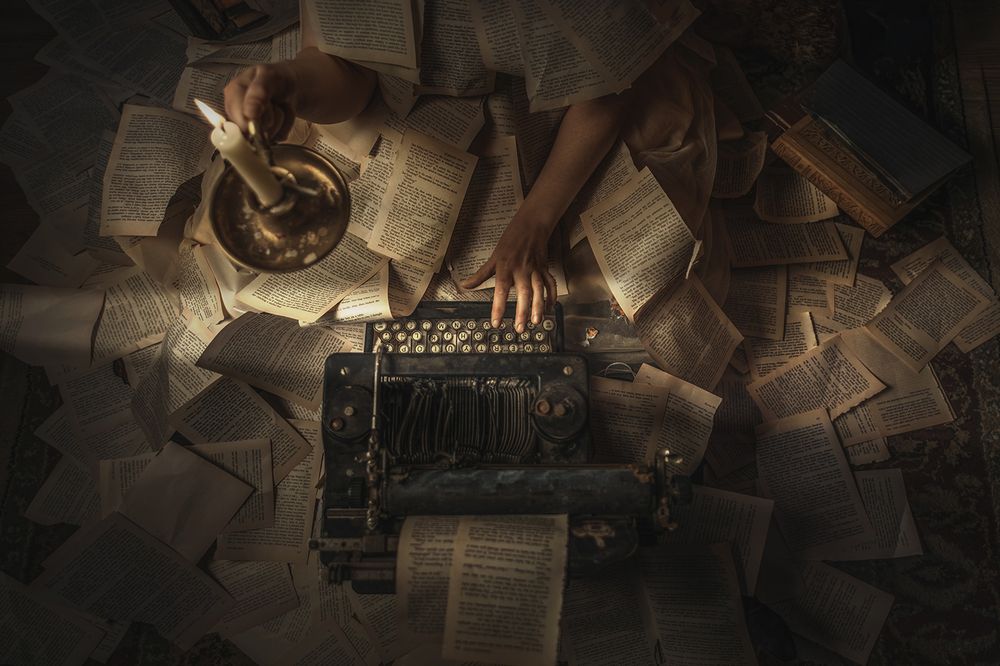 A writer types intensely while pages fly around them, capturing the chaos and energy of the creative process.