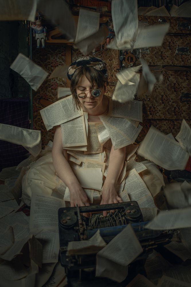 A writer types intensely while pages fly around them, capturing the chaos and energy of the creative process.