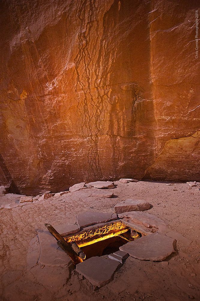 Kiva entrance with hand prints on wall.