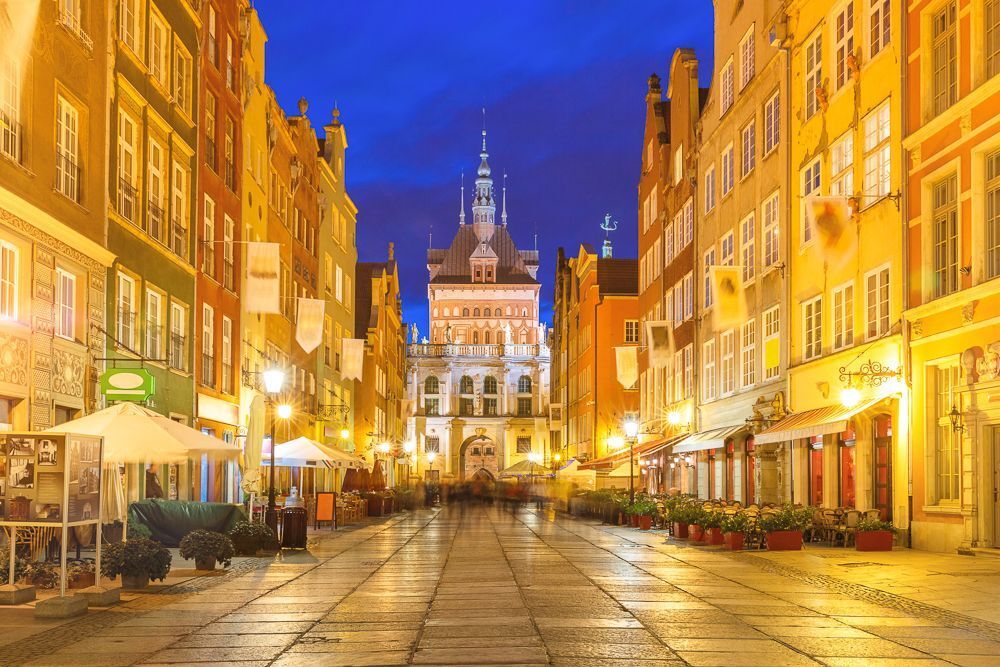 Beautiful historic houses and Golden Gate on Long Lane in Gdansk Old Town at night, Poland