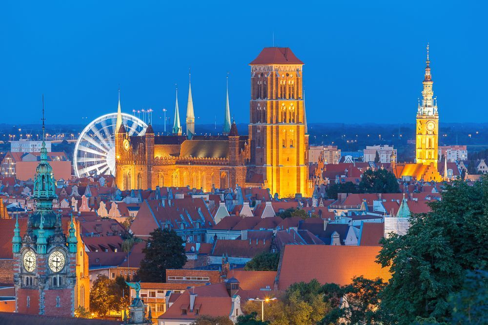 Aerial view of the Saint Mary Church and City Hall at night in Gdansk, Poland