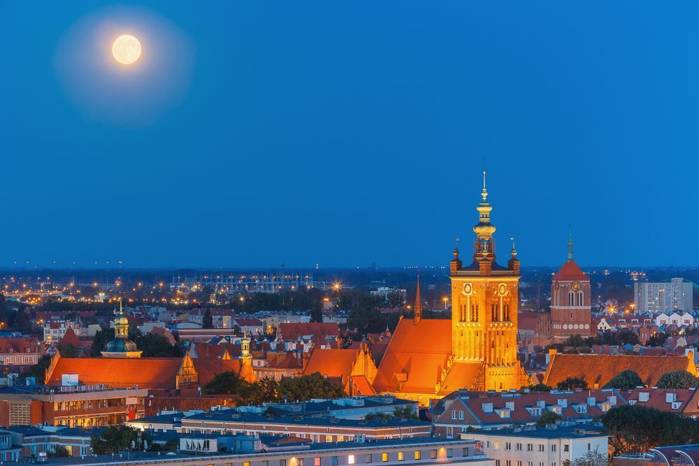 Aerial view of the Church of Saint Catherine at moonlight night in Gdansk, Poland