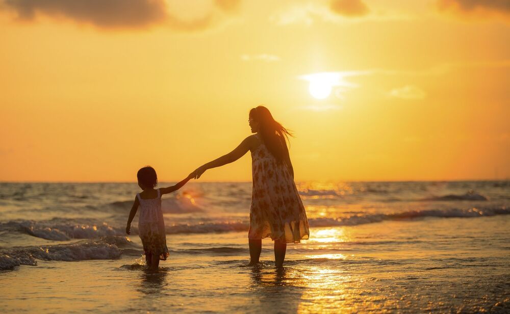 Mother with her daughter on the beach