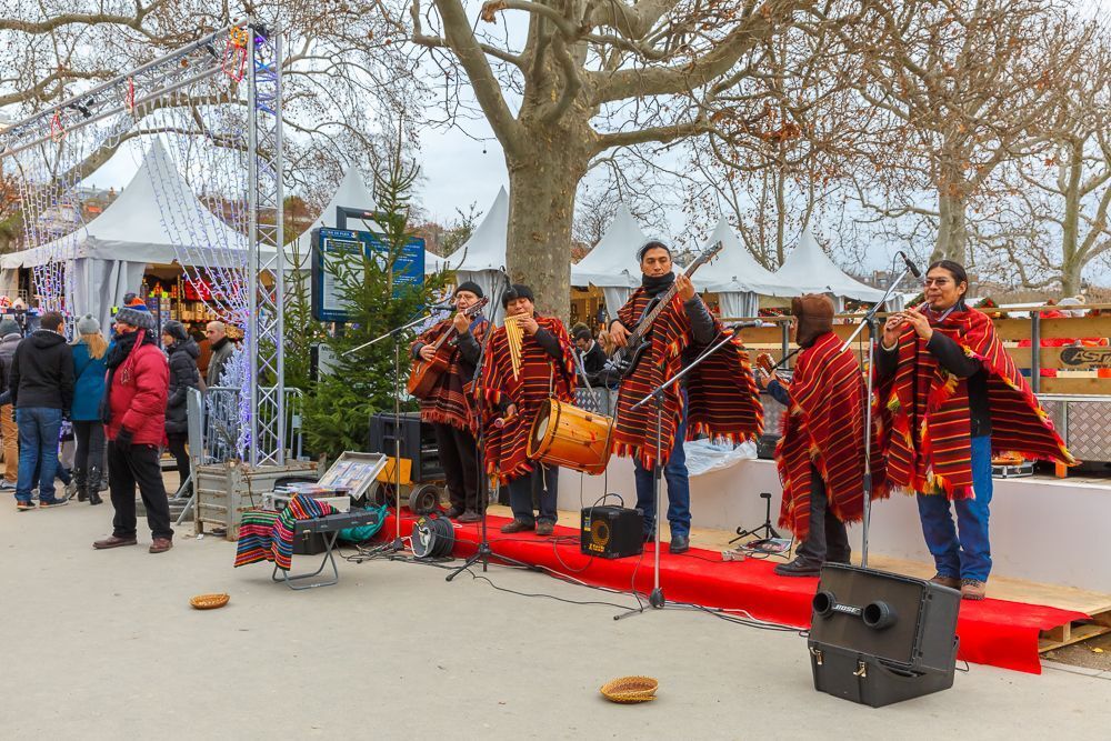 Latin American ensemble buskers in national dress poncho at the Christmas market on the Champ de Mars near the Eiffel Tower
