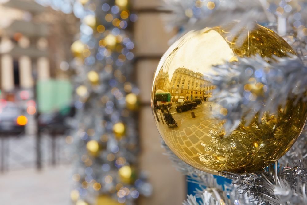 Golden shiny ball on Christmas decorated street in Paris, France