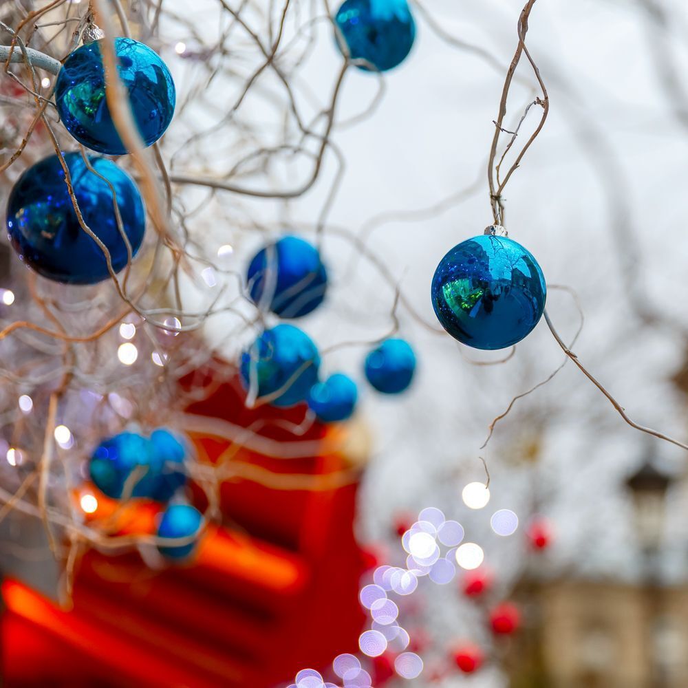 Blue shiny balls on Christmas decorated street in Paris, France