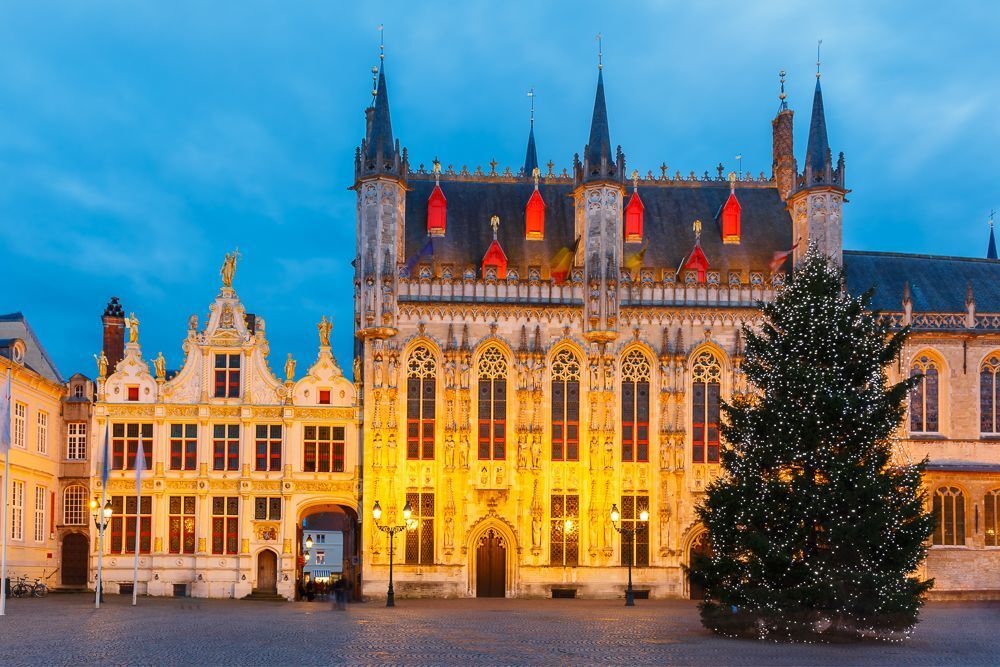 Picturesque night medieval Christmas Burg Square with Christmas tree in Bruges, Belgium.