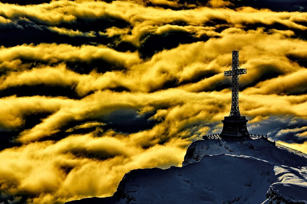 The Heroes' Cross is a monument built between 1926 and 1928 on Caraiman Peak at an altitude of 2,291 m located in Romania, in the Bucegi Mountains of the Southern Carpathians. It has a height of 36 metres (118 ft) and the nearest town is Buşteni. The name of the monument is "The Heroes' Cross", but it is popularly known as the "Cross on Caraiman". The Heroes' Cross is located in the saddle of the Caraiman Mountains, on the slope to the Seacă Valley at an elevation of 2,291 metres (7,516 ft); it is unique in Europe, both by the location's altitude and by the monument's size. The cross itself has a height of 28 metres (92 ft) and two arms of 7 metres (23 ft) each. The monument was the tallest structure in the world situated at such an altitude. The width of the vertical pole is 2 metres (7 ft), the horizontal arms have a length by spindle pole of 7 metres (23 ft), and a square cross section with sides of 2 metres (7 ft). The cross is made out of steel profiles and is mounted on a pedestal of concrete clad with stone 7.5 metres (25 ft) high. Inside the pedestal there is a room that originally housed the electric generator that powered the 120 light bulbs of 500 W each located on the perimeter of the cross.