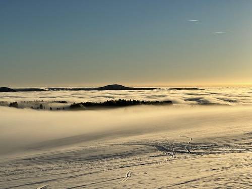 sunset in the snow and fog on top of winter mountain Rhoen Rhön Hesse Germany