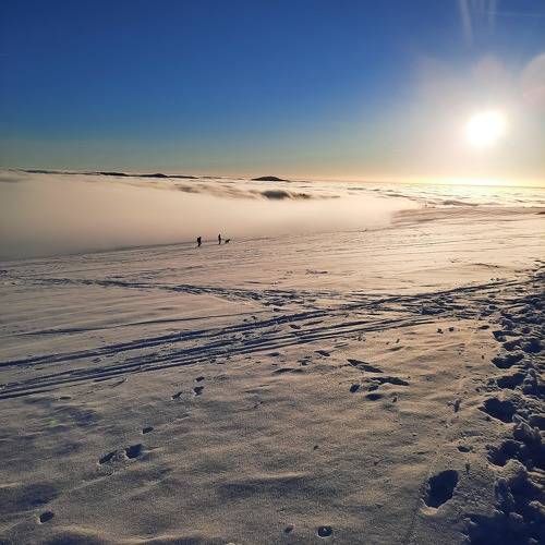 sunset in the snow and fog on top of winter mountain Rhoen Rhön Hesse Germany