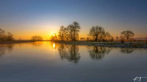 The Gwda River in the glow of the rising sun
