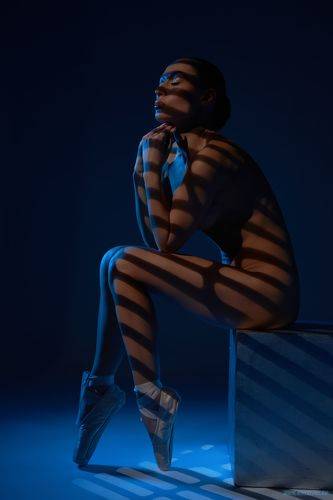 Side view of dreamy alluring fit ballerina in pointe shoes 