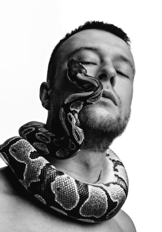 Black and white style portrait of man with snake face фото превью