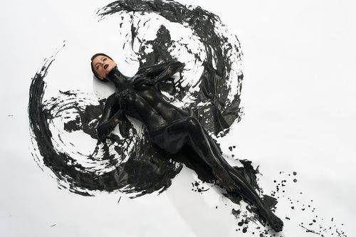 Naked woman with dark oil body art
