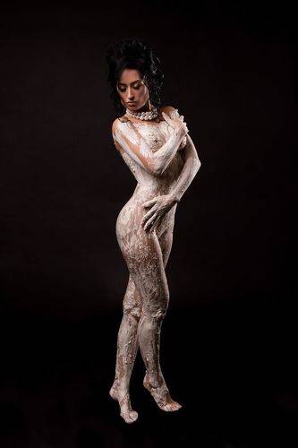 Pretty topless woman in gypsum bodyart
