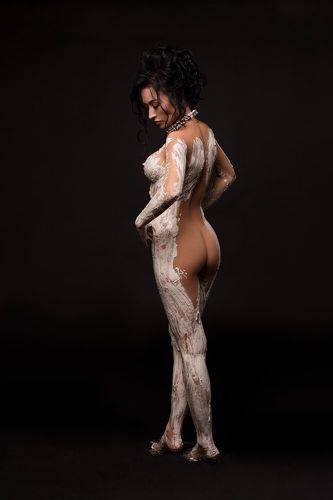 Antique statue concept - Sexy naked woman in gypsum bodyart posing in studio