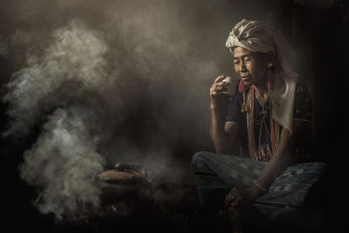 Woman in traditional costumes at Karen drink coffee in Chiang Mai, Thailand.