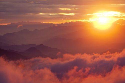 Orange sunset above mountain in valley Himalayas mountains