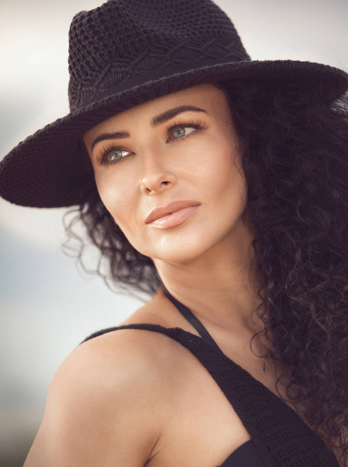 female model,  curly hair, crochet dress, black dress, lady,  elegant, beauty, eyes, moody, black hat, elegant lady, stylish face, stunning woman, Victoria Shamrock
