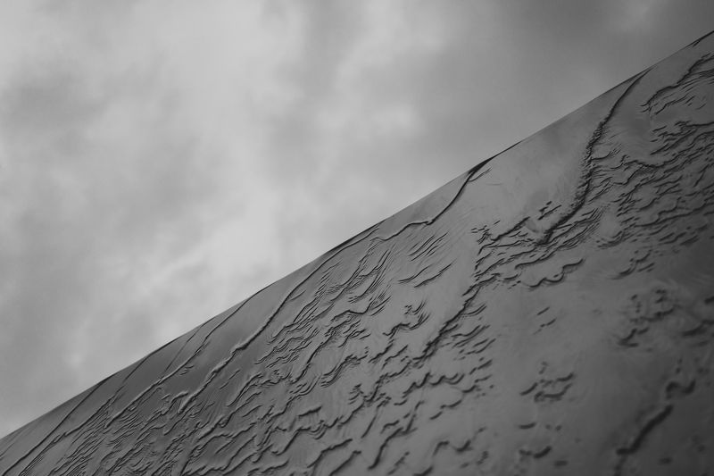 black and white photo, diagonal frame composition, grey cloudy sky contrast, waterfall on slick wall, monochrome landscape, minimalist nature scene, dramatic diagonal division, grey sky and waterfall contrast, contemporary monochrome image, aesthetic diag Water фото превью