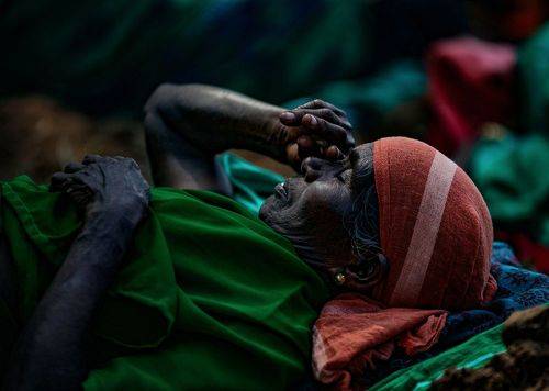 A Worker woman rest beside the farmland