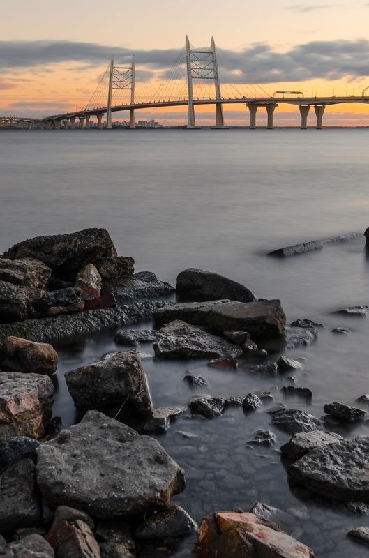 мост, bridge, питер, санкт-петербург, петербург, залив, bay, камни, вода, water, город, city, закат, sunset, облака, небо, cloud, sky Современный мост Петербурга фото превью