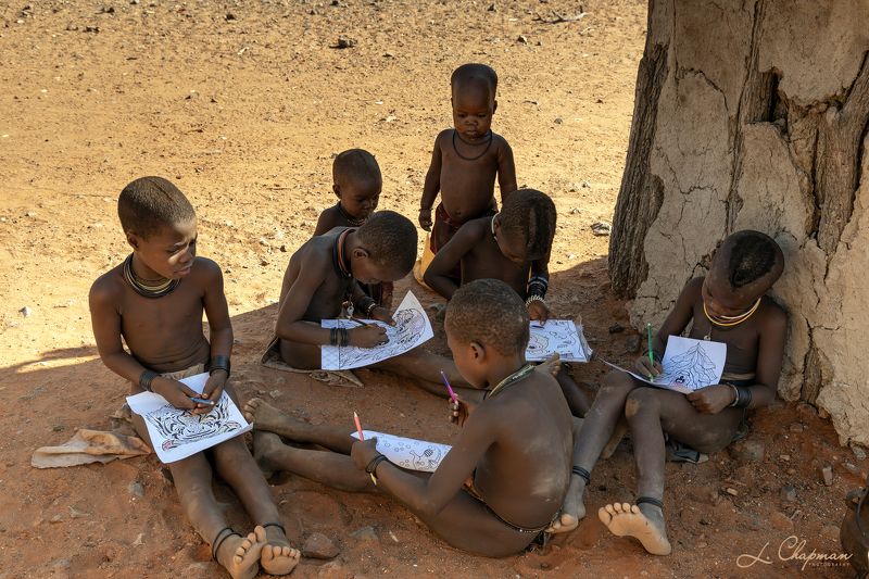 Himba Tribe boys doing homework фото превью