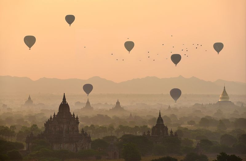 Adventure Ancient Architecture Bagan Built Structure Color Image Dawn Dusk Flying Fog Horizontal Hot Air Balloon Landscape Mandalay Division Mid-Air Myanmar Nature No People Old Ruin On The Move Orange Color Outdoors Photography Religion Scenics Silhouett Balloons over the temples of Bagan фото превью