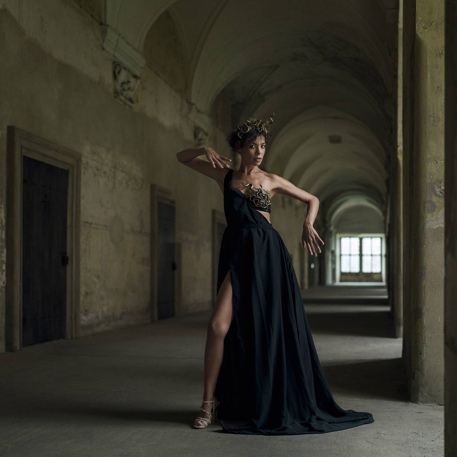 ancient aesthetics, artistic portrait, baroque architecture, cinematic lighting, dramatic photography, emotional depth, front view, golden headdress, historic interior, light and shadow, looking at camera, one person, standing, window, woman, Alex Tsarfin