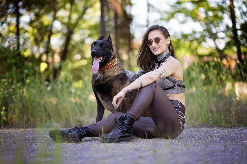 woman with dog, Belgian Malinois, tattoos, urban style, leather pants, female empowerment, alternative fashion, edgy look, loyalty, street portrait, fashion and animal, summer light, outdoor portrait, fierce bond, confident woman Alpha Bond фото превью