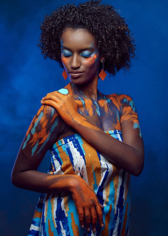 african beauty, amber accents, artistic portrait, body art, creative makeup, curly hair, dark skin, delicate pose, earrings, ethnic style, exotic elegance, female portrait, front view, painted body, shoulder touch, smoke, vibrant colors, young woman Colors of Addis фото превью