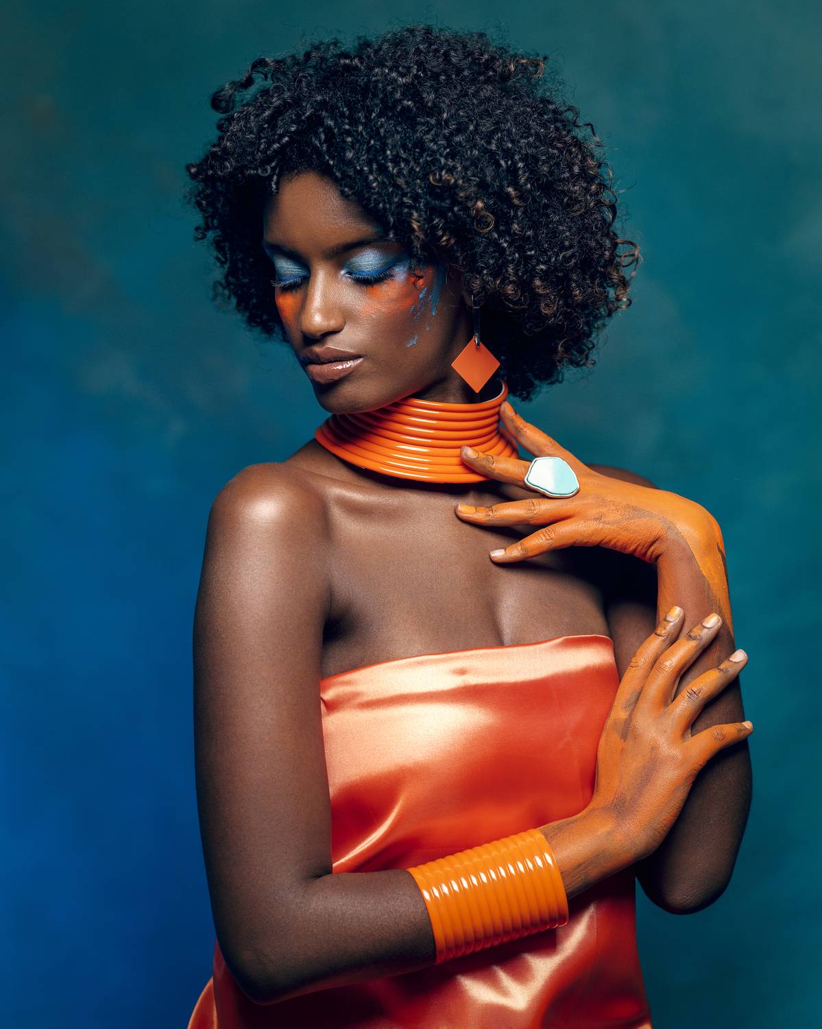 african beauty, amber accents, blue eyeshadow, body art, bracelet, creative makeup, curly hair, dark skin, delicate grace, earrings, elegant pose, ethnic style, exotic elegance, female portrait, front view, necklace, painted body, vibrant colors, Alex Tsarfin