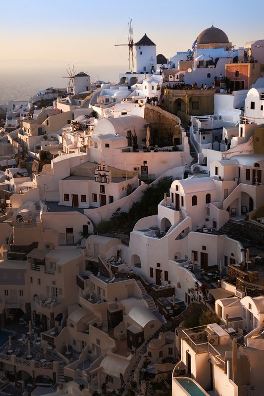 Sunset glow over Oia windmils фото превью