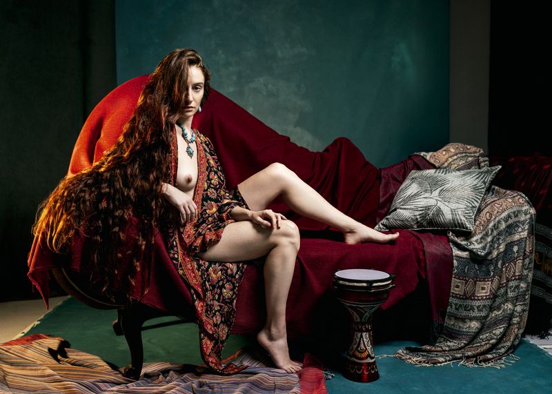 bohemian textiles, draped fabric, emerald background, exotic interior, feminine power, flowing hair, jewel tones, mythic nude, opulent setting, painterly light, poetic sensuality, reclining nude, rich textures, romantic orientalism, sculptural pose Scheherazade Before Dawn фото превью