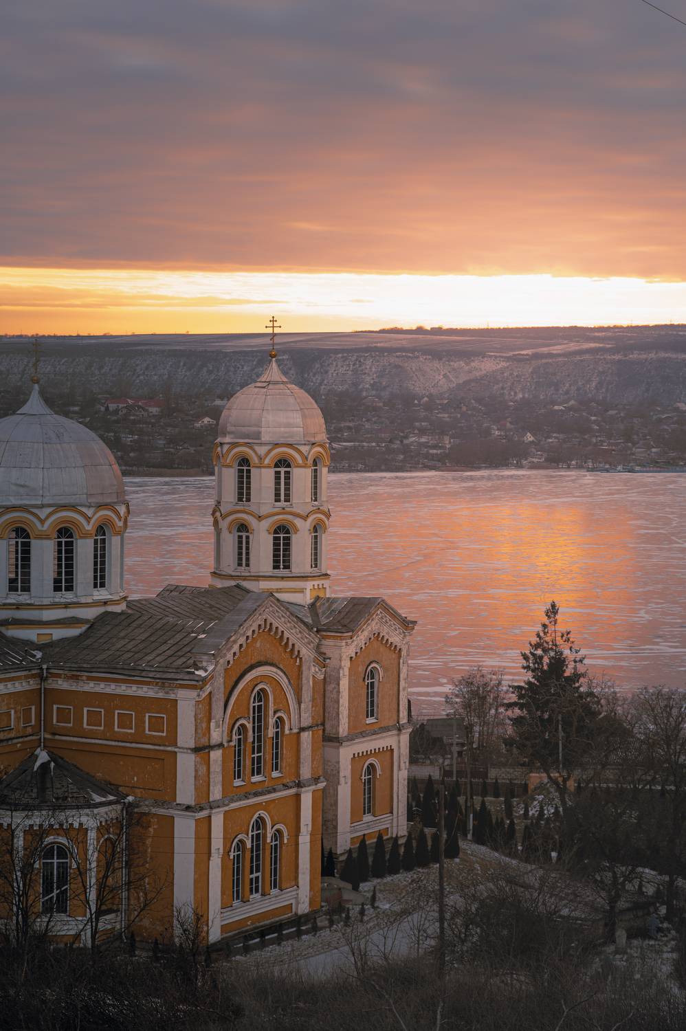 orthodox church, cathedral, winter landscape, sunset light, golden hour, frozen river, reflection, architecture, historic architecture, spirituality, silence, stillness, moody sky, pastel clouds, scenic view, hillside town, eastern europe, fine art photog, Сухенко Олег
