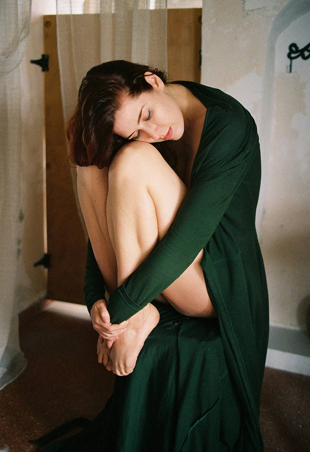 portrait, photography, beauty, film photography, canon ae1, lomography, analog photography, film grain, warm tones, intimate portrait, green dress, self embrace, contemplative, emotional, soft light, vintage interior, artistic portrait, fine art photograp, Rozman Erik