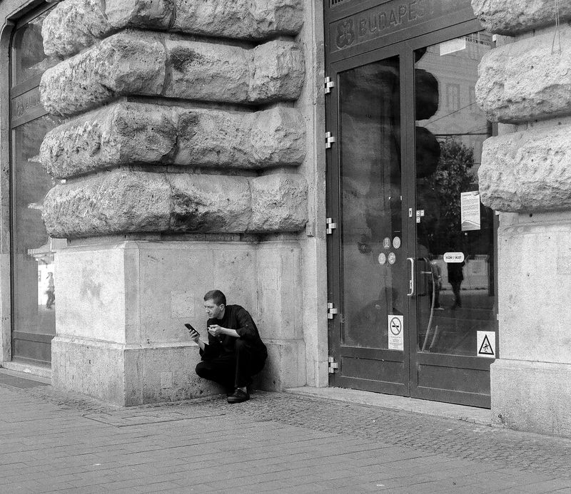 street, photography, monochrome, black, white, urban, city, candid, architecture, stone, facade, doorway, solitude, figure, man Solitude Between Stone and Glass (Budapest) фото превью