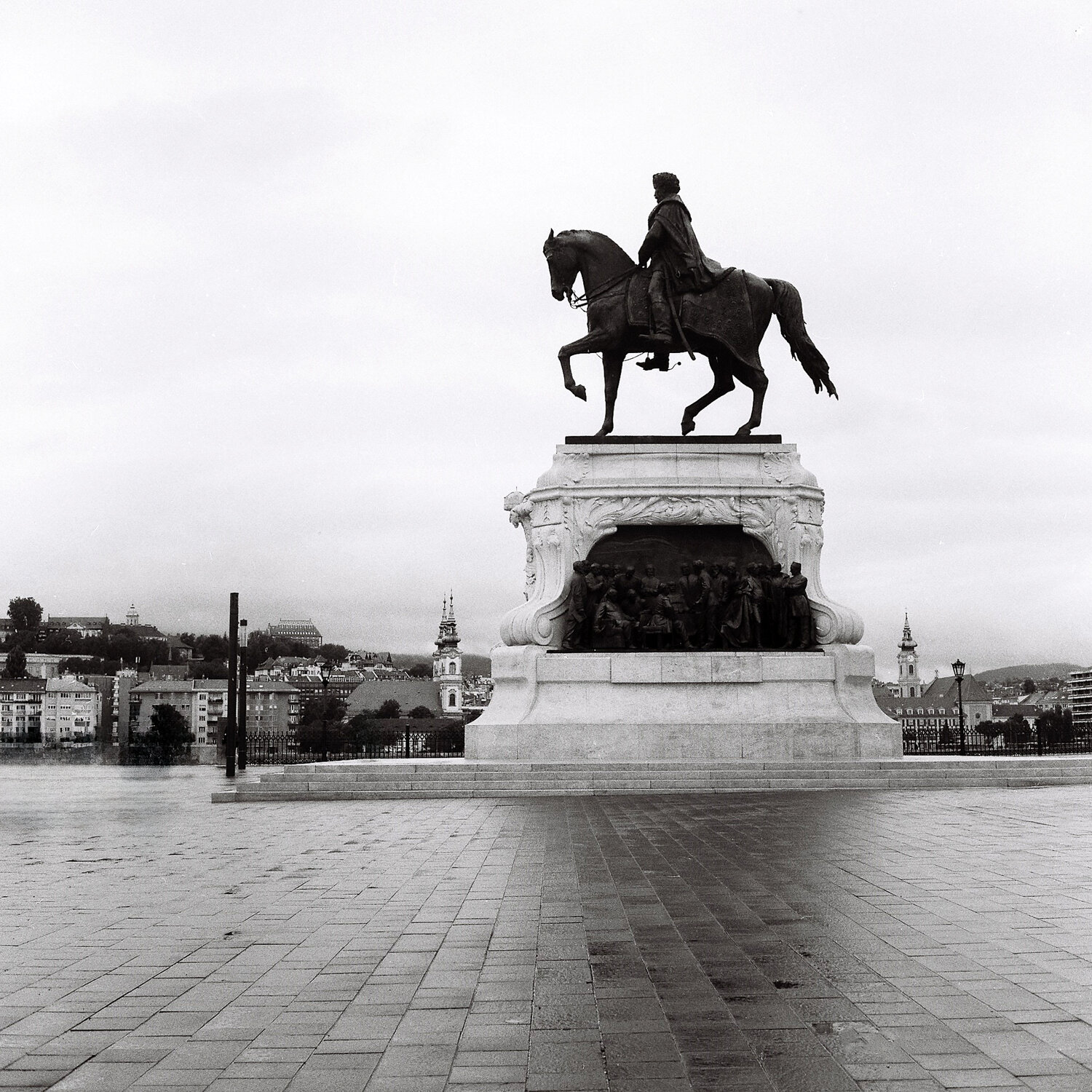 blackAndWhite, equestrianStatue, monument, urbanLandscape, filmPhotography, analogPhotography, architecturalPhotography, publicSquare, cobblestone, cityscape, sculpture, bronzeStatue, monumentalArchitecture, emptySpace, minimalism, Rozman Erik